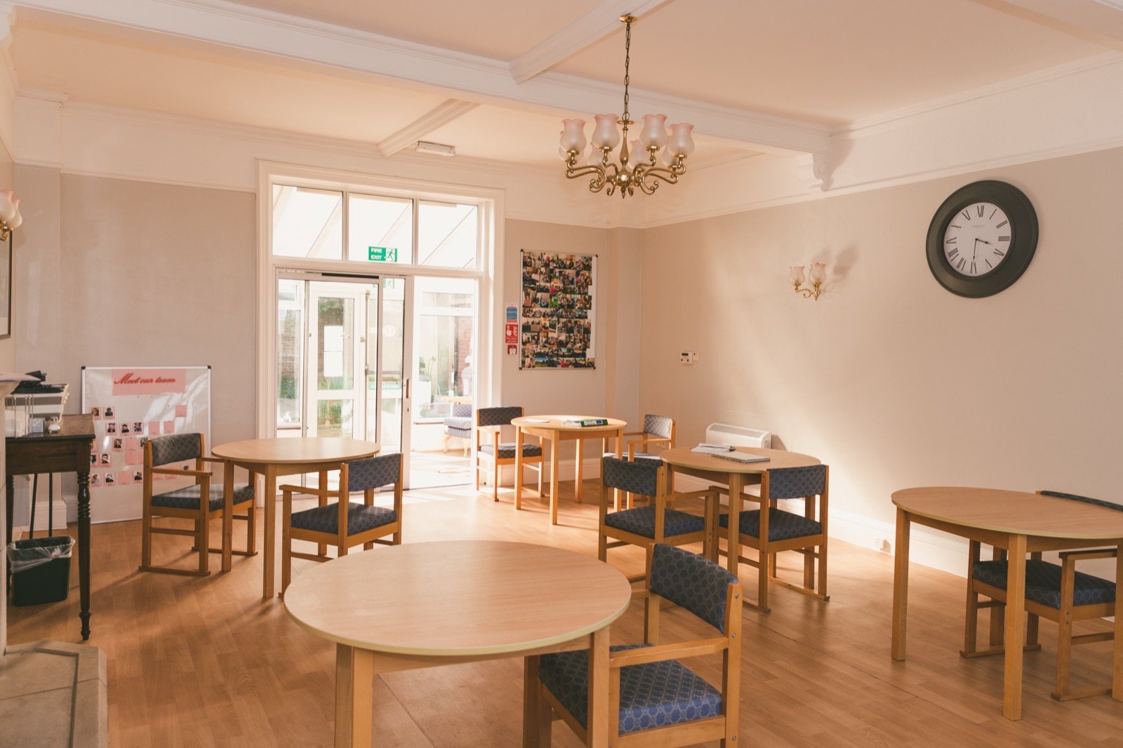 Bright, homely lounge with television, bookshelf and armchairs