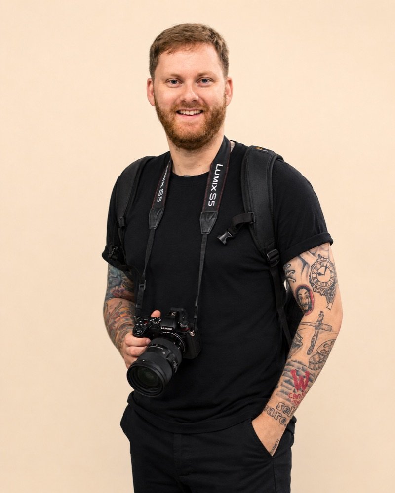 Lewis, founder of Open Door Films, holding a camera on location